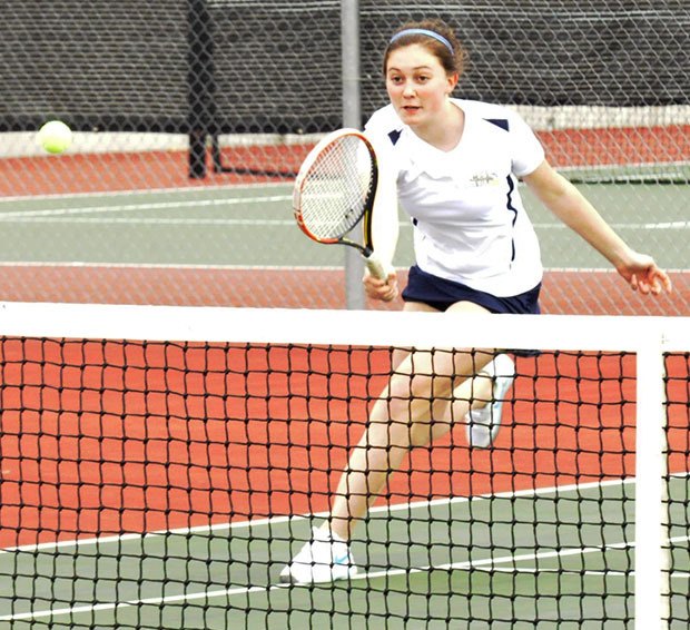 An Arlington tennis player keeps a volley alive.