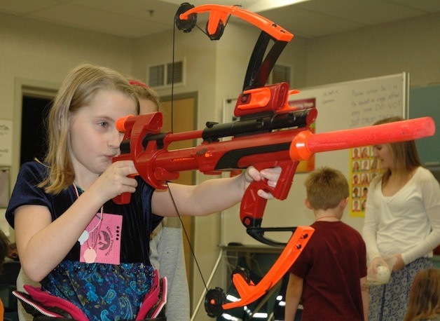 Nikole Christian takes aim with a Nerf crossbow during the March 6 Kent Prairie Elementary Kiddies' Carnival.