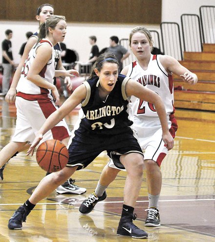 Arlington sophomore guard Krista Showalter penetrates the Marysville-Pilchuck defense.