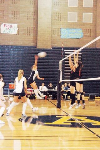 :  Arlingtons Ryanne Mueller smacks this kill down on the Monroe defense during the Eagles Oct. 18 match.