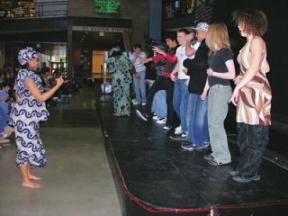 Arlington High School students are drawn on stage by members of the Seattle-based Life Enrichment Group