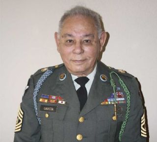 Eliseo Garcia still fits into his military dress uniform. He enlisted in the Army at the age of 15