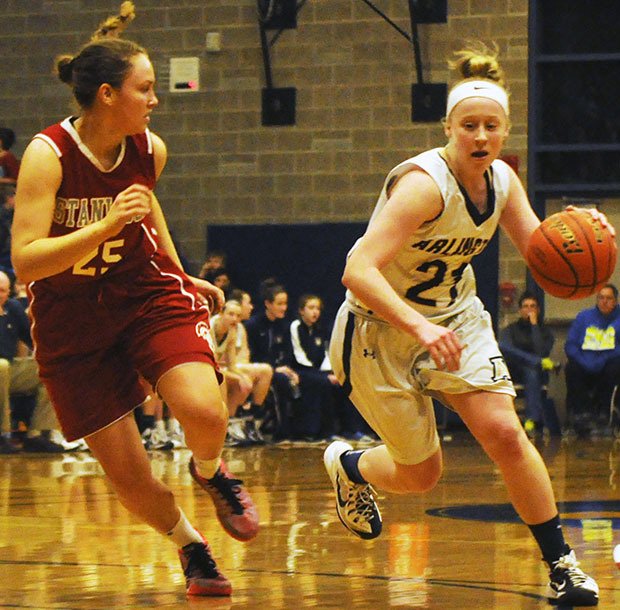 Arlington's Emma Janousek dribbled inside key.