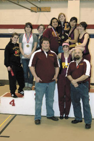 The Lakewood girls wrestling team enjoys their moment on the podium. Front row