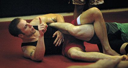 Matt Coble instructs techniques to get an opponent to submit during a grappling class at the Arlington Kickboxing Club.