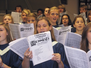 Arlington High School choral students warm up for the upcoming community choir's presentation of Handel's 'Messiah' set for Dec. 14. Choir director Lyle Forde has announced a call for singers from the community.