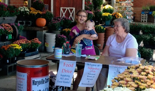 Ashley and Ari Nelson join fellow volunteer Betty Wammack in collecting food and financial donations for local food banks at the Marysville Haggen on Sept. 9.