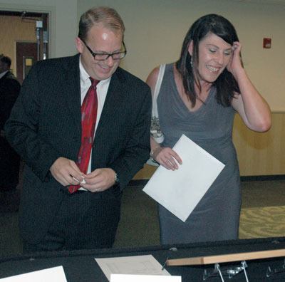 Steve and Brandi Peiffle examine a wooden cutting board up for bid during the silent auction of the Arlington-Smokey Point Chamber of Commerce’s 10th annual Black & White Gala on Sept. 21.