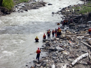 A team of about 15 fire fighters and medics learn techniques for rescuing people out of fast moving rivers at a five-hour training Sunday