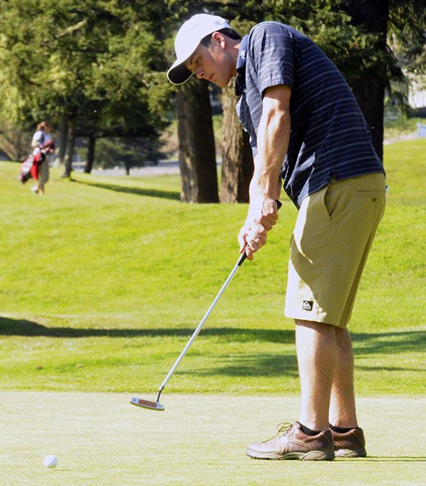 An Arlington golfer putts during the Wesco 3A tournament at Cedarcrest Golf Course April 20.