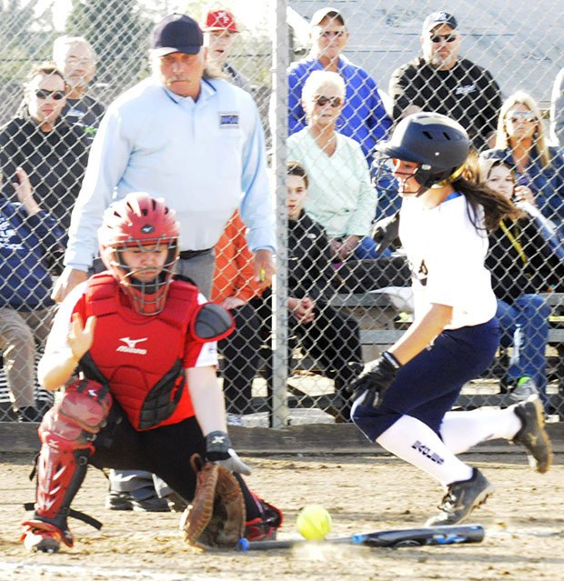 An Arlington player slides home against Marysville-Pilchuck catcher.