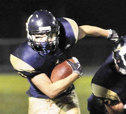 Arlington junior halfback Colton Hordyk eyes the end zone as he runs for one of his four touchdowns after shedding a Jackson tackler.