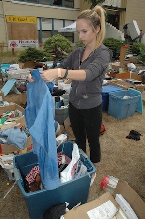 Highland Christian School senior Abby Cloutier sorts through clothes during the school's Aug. 24 garage sale.