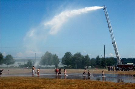 Residual mists from the Arlington Fire Department ladder truck’s “Giant Water Shower” could be felt hundreds of feet away from the sides of the stream itself July 26