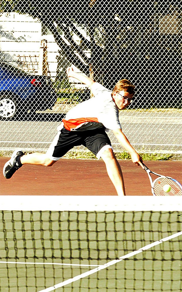 M-P junior Logan plant keeps a volley to his backhand alive.