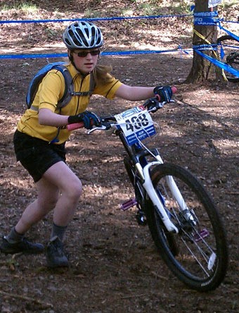 Arlington’s Hannah Mendro pushes herself uphill during the inaugural Washington State High School Mountain Bike Championships on May 1.