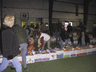 The members of the Rotary Club of Arlington prepare 55 baskets to deliver to people in need Dec. 18.