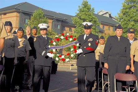 Naval Station Everett's Fire Captain Mike Kazikiewicz and Chief Master at Arms (SW) Winston Preston present a wreath in memory of Sept. 11