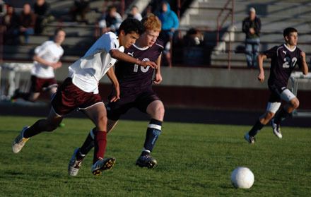 Joseph Hawkins fights with a Sultan defender for possession. Hawkins had a goal and an assist in Lakewood's 3-1 victory.