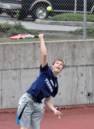 Arlington’s Brandon Kennedy reaches to return a volley against Snohomish.