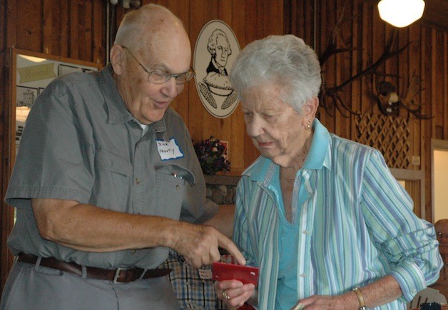 Dick Prouty presents 91-year-old Martha Young with a gift certificate for being the oldest woman born in the valley at the Stillaguamish Valley Pioneer Association's Aug. 17 picnic.