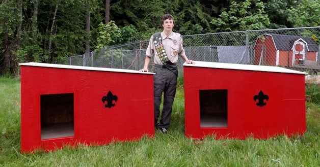 Eagle Scout Nick Moore presents some of the doghouses he built for the Humane Society of Arlington.