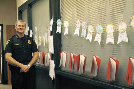 Arlington Police Chief Robert Sullenberger stands near a collection of letters