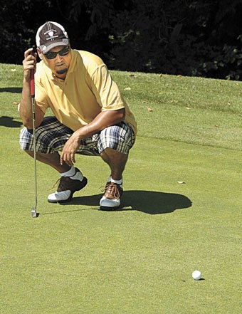 Bob Scott studies his shot during the second annual Arlington Open at the Gleneagle Golf Course on Aug. 26.