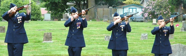 Members of the Arlington High School Air Force Junior ROTC render a gun salute to the fallen at Arlington Cemetery for Memorial Day.