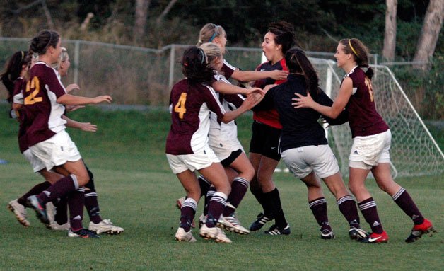 Lakewood players rush to celebrate with goalkeeper Miranda Head after defeating Archbishop Murphy in a shootout.