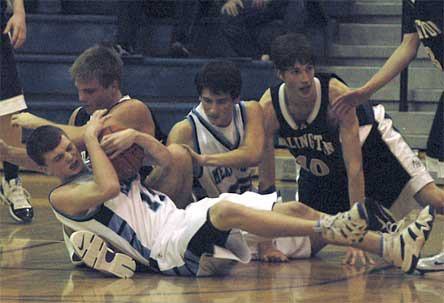 A scrum breaks out for a loose ball in a physical first half. Meadowdale's Spencer Linton