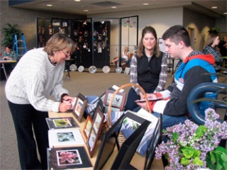 Austin Smith shows his photography at the recent Arlington High School Arts Festival. The arts festival was held in the foyer of the Byrnes Performing Arts Center while the school’s annual plant sale took place in the greenhouse behind the high school. During the weekend