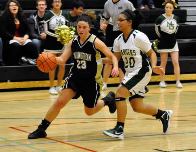 Arlington senior guard Megan Abdo takes control of a loose ball against Marysville Getchell junior guard Kayann Gamalinda on Dec. 27.