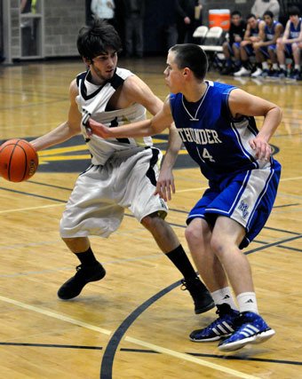 Arlington senior guard Conner Davis protects the ball against Mountain View junior guard Rock Shill on Dec. 28.