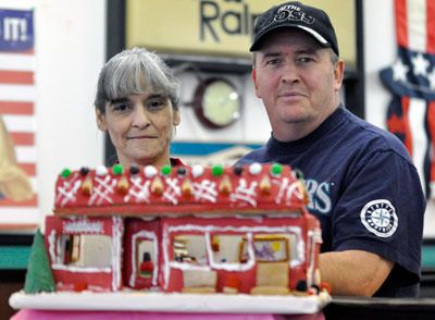 Local Scoop employee Christine Baker and her husband Curtis display their gingerbread replica of The Local Scoop that won the Adult and People’s Choice awards.