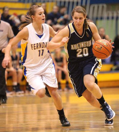 Arlington junior guard Krista Showalter drives past Ferndale junior guard Taylor Reid in an interconference game at Ferndale on Dec. 22.