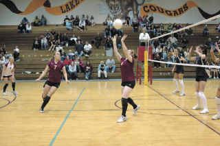 Senior setter Peyton Mizell sets the ball for hitter Megan Eby. Lakewood defeated Granite Falls in five games at home Oct. 16.