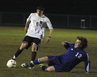 Junior midfielder Brandon Ochoa fires a shot just before colliding with a South Whidbey defender.