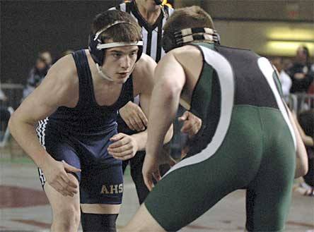 Arlington senior grappler Dustin Ward prepares to shoot on his opponent at 152 pounds.