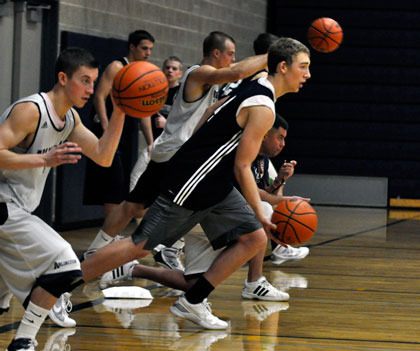 Arlington boys hoops players practice ball-handling while sprinting.