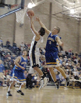 Senior guard Will Heath eludes Ferndale’s Jeff Frost as he tries to block Heath’s shot from behind.