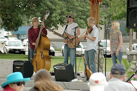 Members of A Well-Known Stranger play for a crowd of more than 50 at Marysville’s Comeford Park.