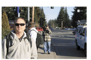 Shane Werner waits for the bus on Smokey Point Boulevard