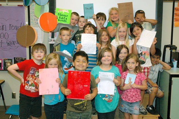 Christine Cobb’s first-grade students at Eagle Creek Elementary show off their ‘novels’ prior to the school’s ‘Young Authors Day’ on June 7.