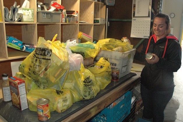 Arlington Community Food Bank volunteer Kortney Todd weighed hundreds of pounds of donated food during last year's Letter Carriers' Food Drive.