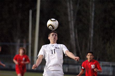 Eagles senior forward Jake Smith connects on a header to bring the ball down to his feet.