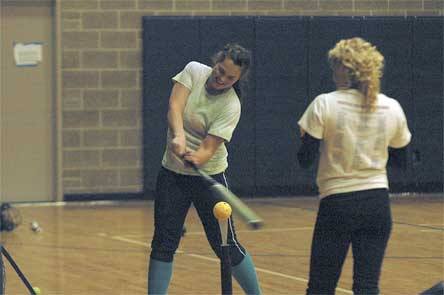 Kailee Basher practices her swing indoors during Arlington's turnout.