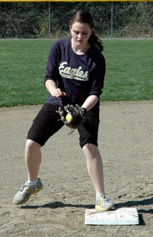 Arlington High School junior Kaylyn Myers demonstrates catching at the AHS girls softball clinic on March 30.