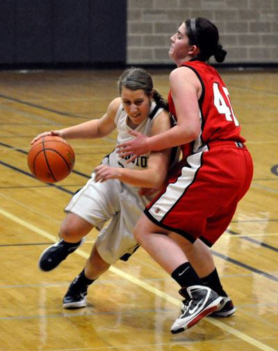 Arlington junior guard Krista Showalter drives to get around Snohomish senior forward Melissa Dreves in the Eagles’ 52-39 win over the Panthers on Dec. 16.