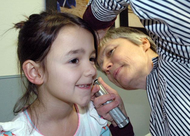 Marysville’s Aaralyn Martin is checked out by Arlington pediatrician Dr. Doina Stefan to make sure she hasn’t caught the flu since having her adenoids removed.